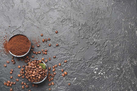 Bowls with coffee beans and powder on gray backgroundの写真素材