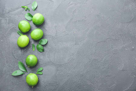 Fresh limes on dark background