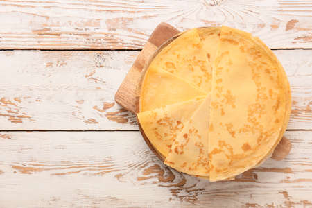 Tasty blini on wooden background