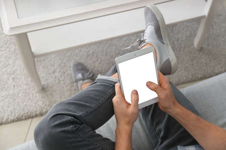 Handsome man with tablet computer at home