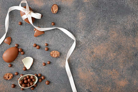 Chocolate eggs and candies on gray table