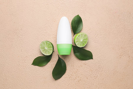 Deodorant and lime on color background