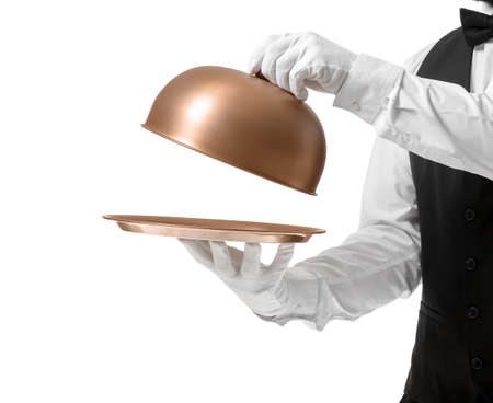 Handsome male waiter with tray and cloche on white backgroundの写真素材