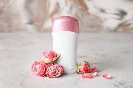 Deodorant and flowers on light tableの写真素材