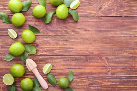 Fresh limes on wooden backgroundの写真素材
