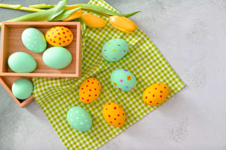 Boxes with beautiful Easter eggs on light backgroundの写真素材