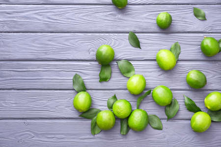 Fresh limes on wooden backgroundの写真素材