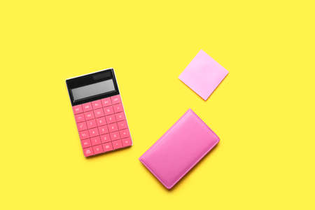 Modern calculator with stationery on color backgroundの写真素材