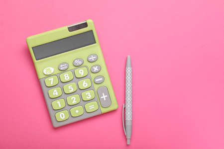 Modern calculator with pen on color backgroundの写真素材
