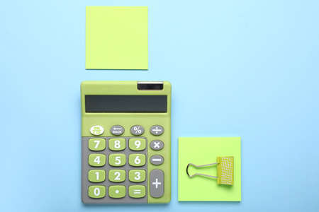 Modern calculator with stationery on color backgroundの写真素材