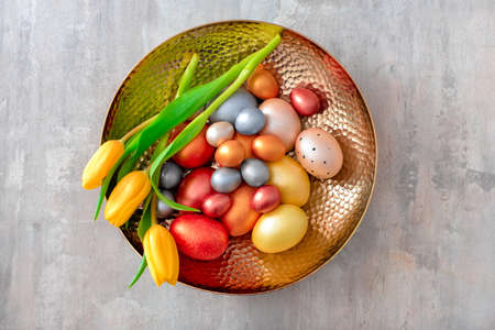 Tray with beautiful Easter eggs on gray backgroundの写真素材