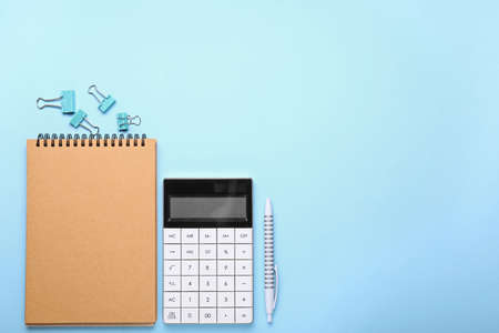 Modern calculator with stationery on color backgroundの写真素材