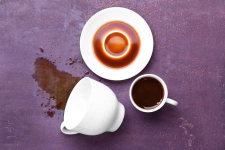 Composition with spilled coffee on tableの写真素材
