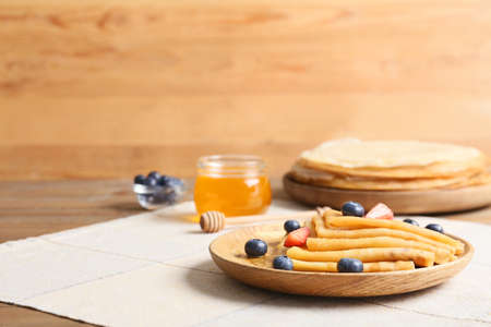 Tasty blini with berries on tableの写真素材
