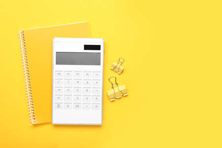 Modern calculator with stationery on color backgroundの写真素材