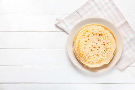 Plate with tasty blini on tableの写真素材