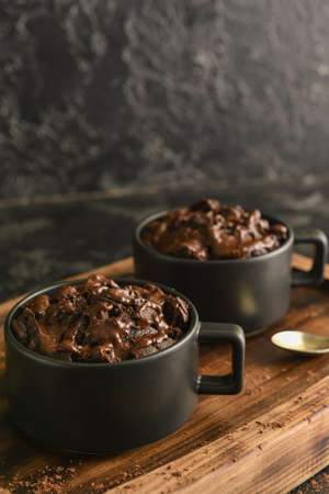 Chocolate mug cakes on wooden board