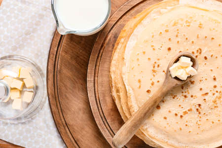 Tasty blini with butter on tableの写真素材