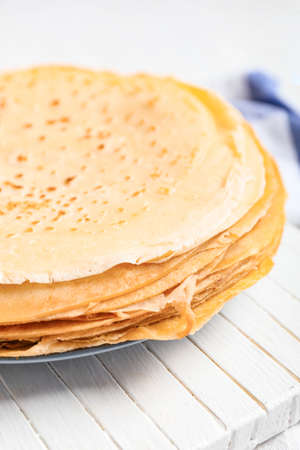 Board with tasty blini on table, closeupの写真素材