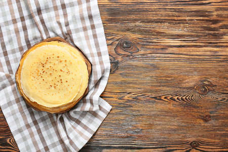 Board with tasty blini on tableの写真素材