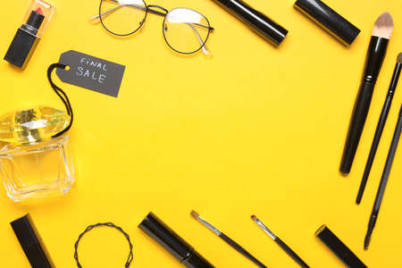 Frame made of perfume for sale with makeup cosmetics and accessories on color backgroundの写真素材