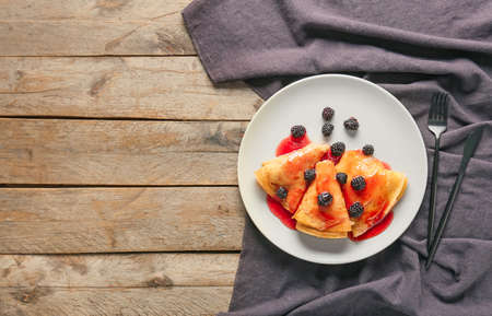 Tasty blini with berries on tableの写真素材