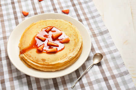 Tasty blini with berries on tableの写真素材