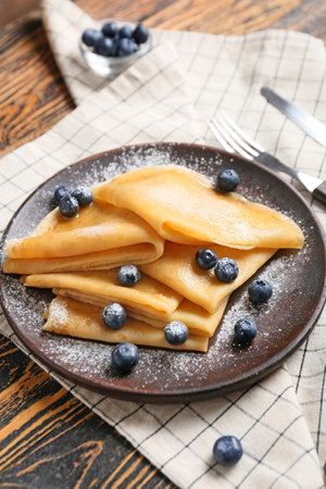 Tasty blini with berries on tableの写真素材