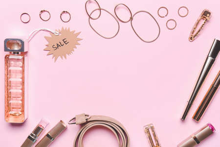 Frame made of perfume for sale with makeup cosmetics and accessories on color backgroundの写真素材
