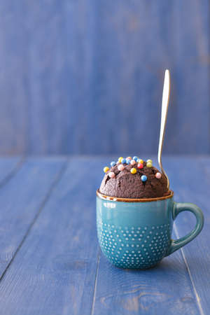 Chocolate mug cake on tableの写真素材