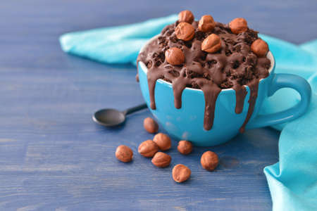 Chocolate mug cake with nuts on tableの写真素材