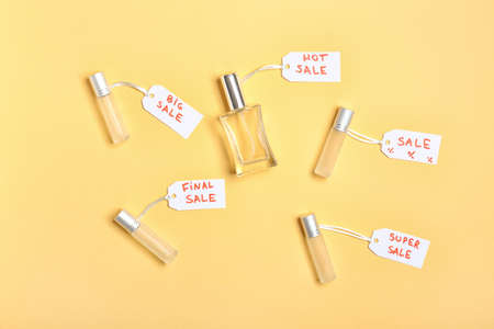 Bottles of perfumes for sale on color backgroundの写真素材