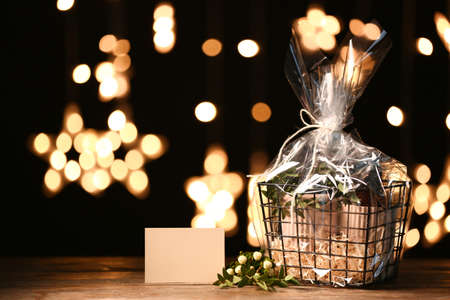 Basket with gifts for Mother's Day on table against dark backgroundの写真素材