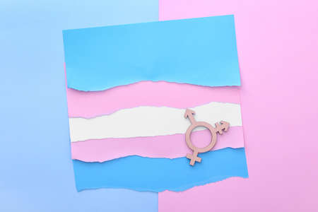 Flag made of paper and symbol of transgender on color backgroundの写真素材