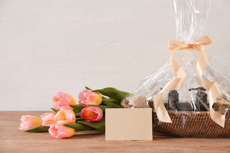 Basket with gifts and flowers for Mother's Day on tableの写真素材