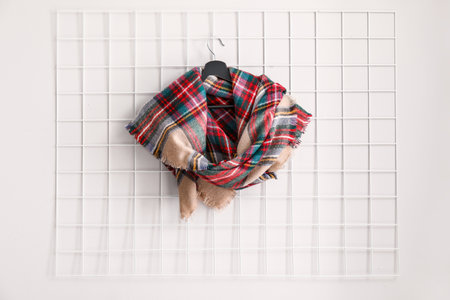 Hanger with beautiful scarf on white wallの写真素材