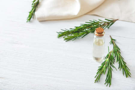 Bottle of rosemary essential oil on tableの写真素材