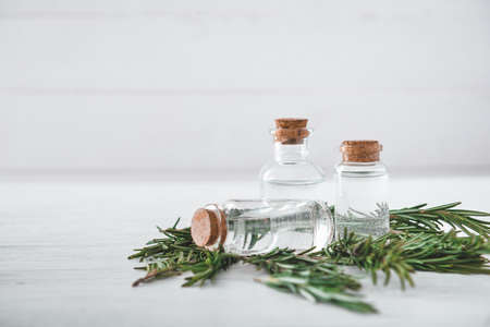 Bottles of rosemary essential oil on tableの写真素材