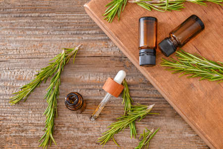 Bottles of rosemary essential oil on tableの写真素材