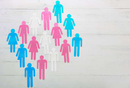 Human figures on white wooden background. Concept of transgenderの写真素材