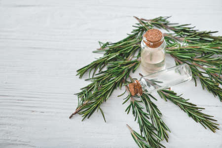 Bottles of rosemary essential oil on tableの写真素材