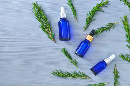 Bottles of rosemary essential oil on tableの写真素材