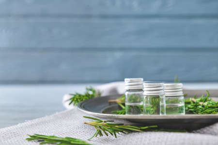 Bottles of rosemary essential oil on tableの写真素材