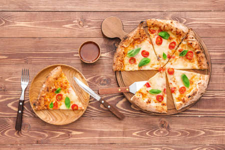 Composition with delicious pizza Margherita on wooden backgroundの写真素材