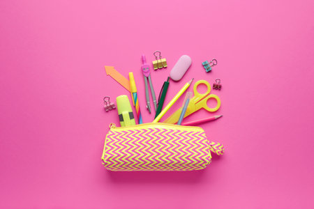 Pencil case and stationery on color background
