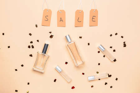 Bottles of perfumes for sale on color backgroundの写真素材
