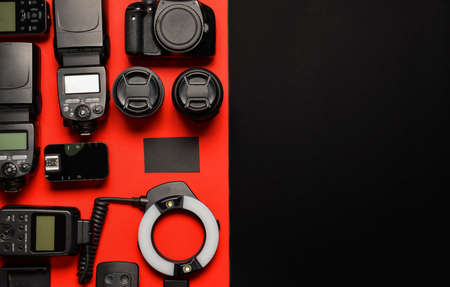 Modern photographer's equipment with card on color backgroundの写真素材