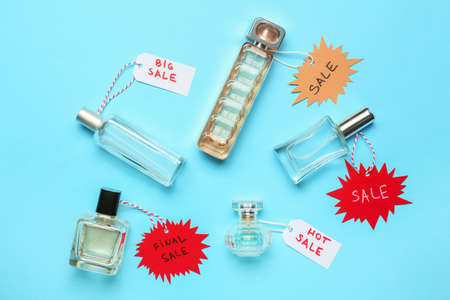 Bottles of perfumes for sale on color backgroundの写真素材