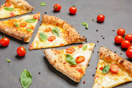 Delicious cut pizza Margherita on gray backgroundの写真素材