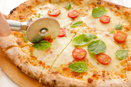 Cutting of delicious pizza Margherita, closeupの写真素材